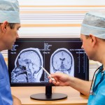 Two doctors examining an MRI scan