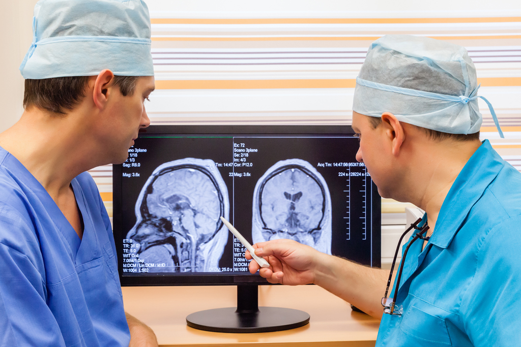 Two doctors examining an MRI scan